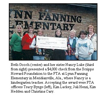 Beth Gooch and her sister Nancy present check to PTA